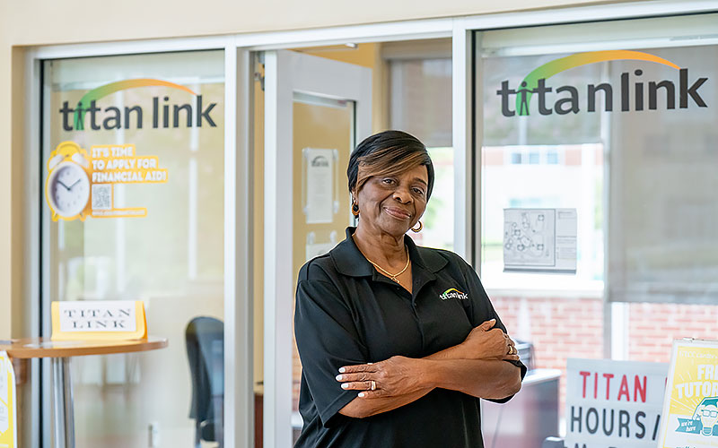 Brenda Mackey poses in front of the Titan Link office on the Greensboro Campus.