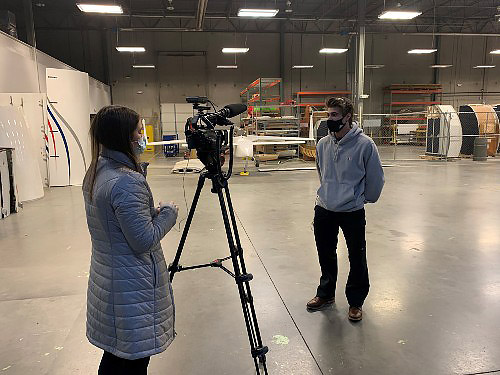 WFMY reporter Jenna Kurzyna interviewing aviation student LIam McCann. 