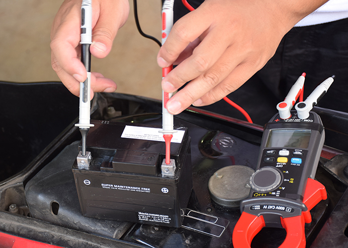 A person checks a battery to make sure it still has juice.