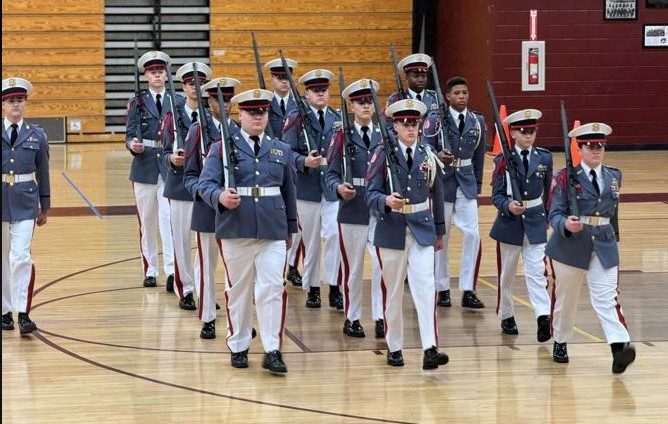 ORMA cadets participate in a formal marching drill in the gym.