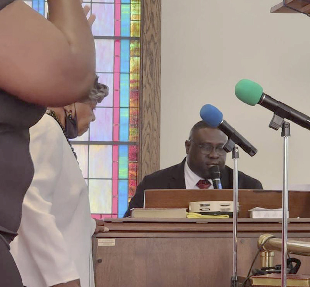 Johnnie Draft III plays piano at a church.